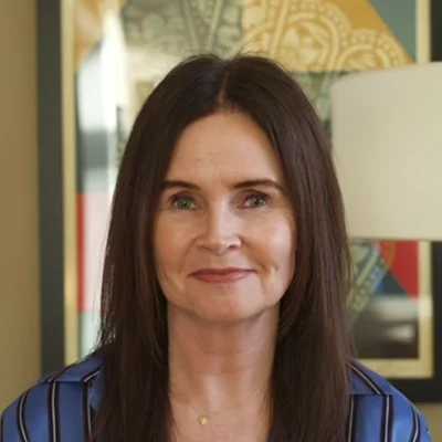 A headshot photo of Tracy